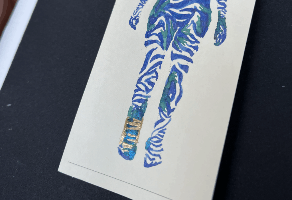 the close up on the feet and les, showing mostly the reflections in the lower limb, cool green ink with blue shimers and gold metal paint pen of two metal plates and multiple short and long metal screws.